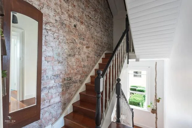 Victorian terrace staircase with exposed sandstock brick wall, Potts Point