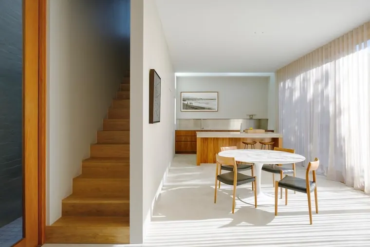 Open plan living and dining with a timber staircase at the Queens Park renovation, painted by Proview Painting