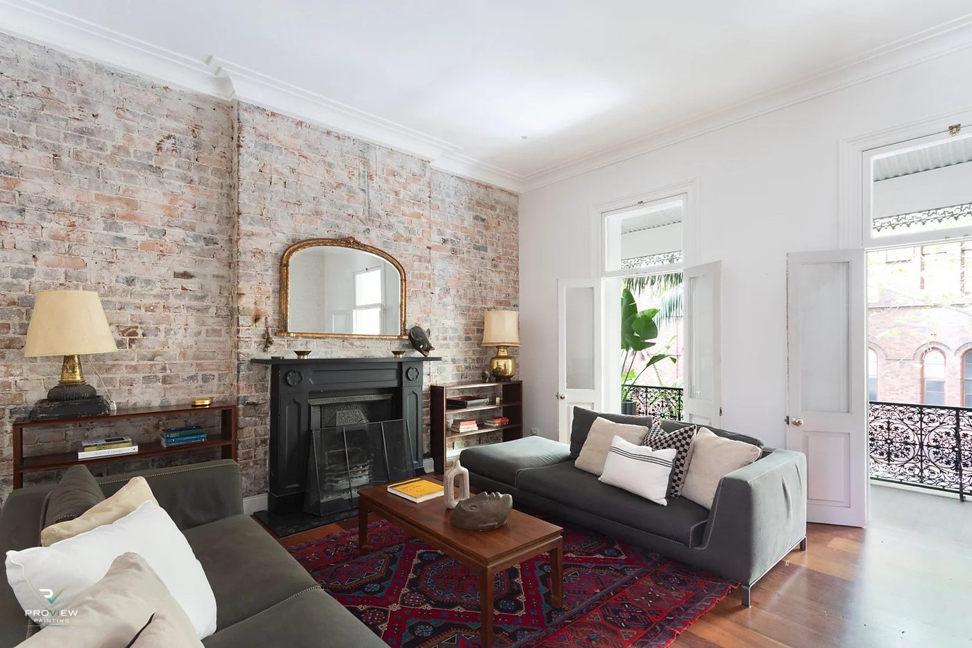 Potts Point — living room with exposed brick and fireplace