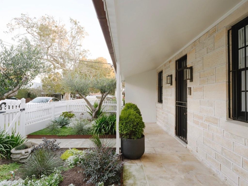 Heritage sandstone exterior with white picket fence