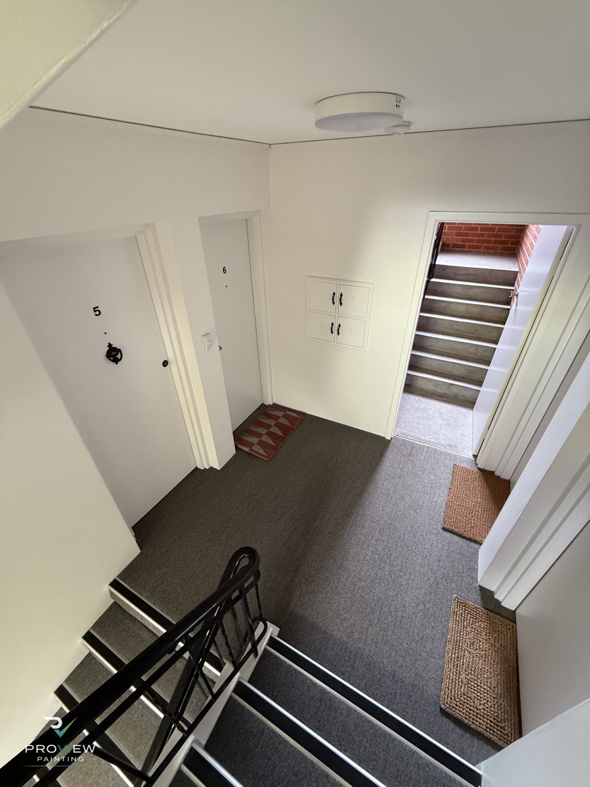 Repainted common-area stairwell and landing inside the Mosman strata block